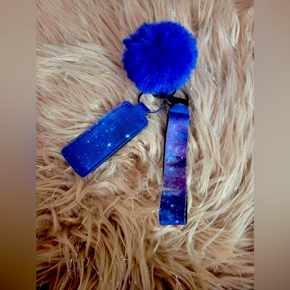 Galaxy wristlet with chapstick holder and fuzzy ball